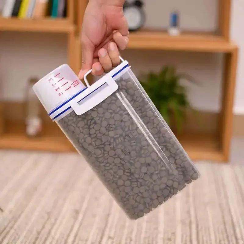 Hand holding a transparent bag with gray beads against a blurred indoor background