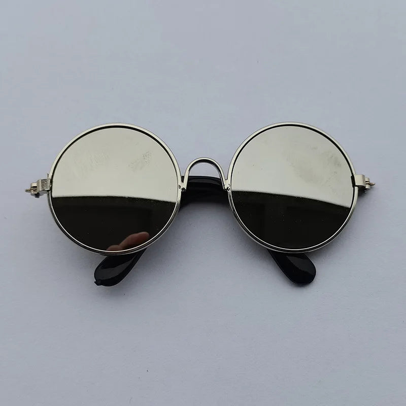 Round sunglasses with reflective lenses on a light gray background