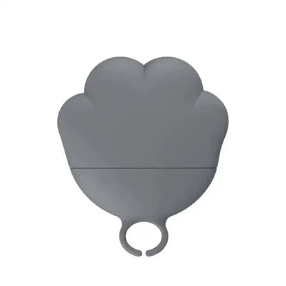 Gray heart-shaped object with a ring on a white background