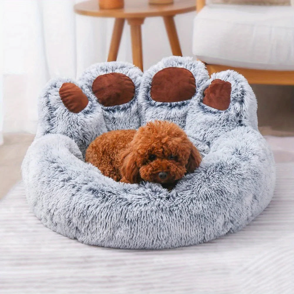 Dog lying on a gray paw-shaped pet bed in a cozy room.