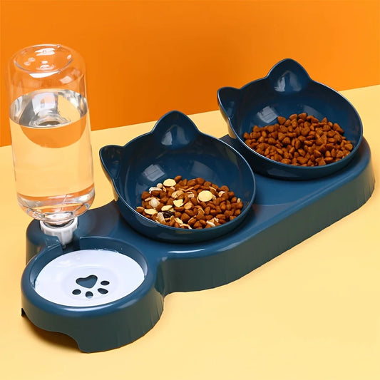 Pet feeding station with two bowls of food and a glass of water on a yellow surface.
