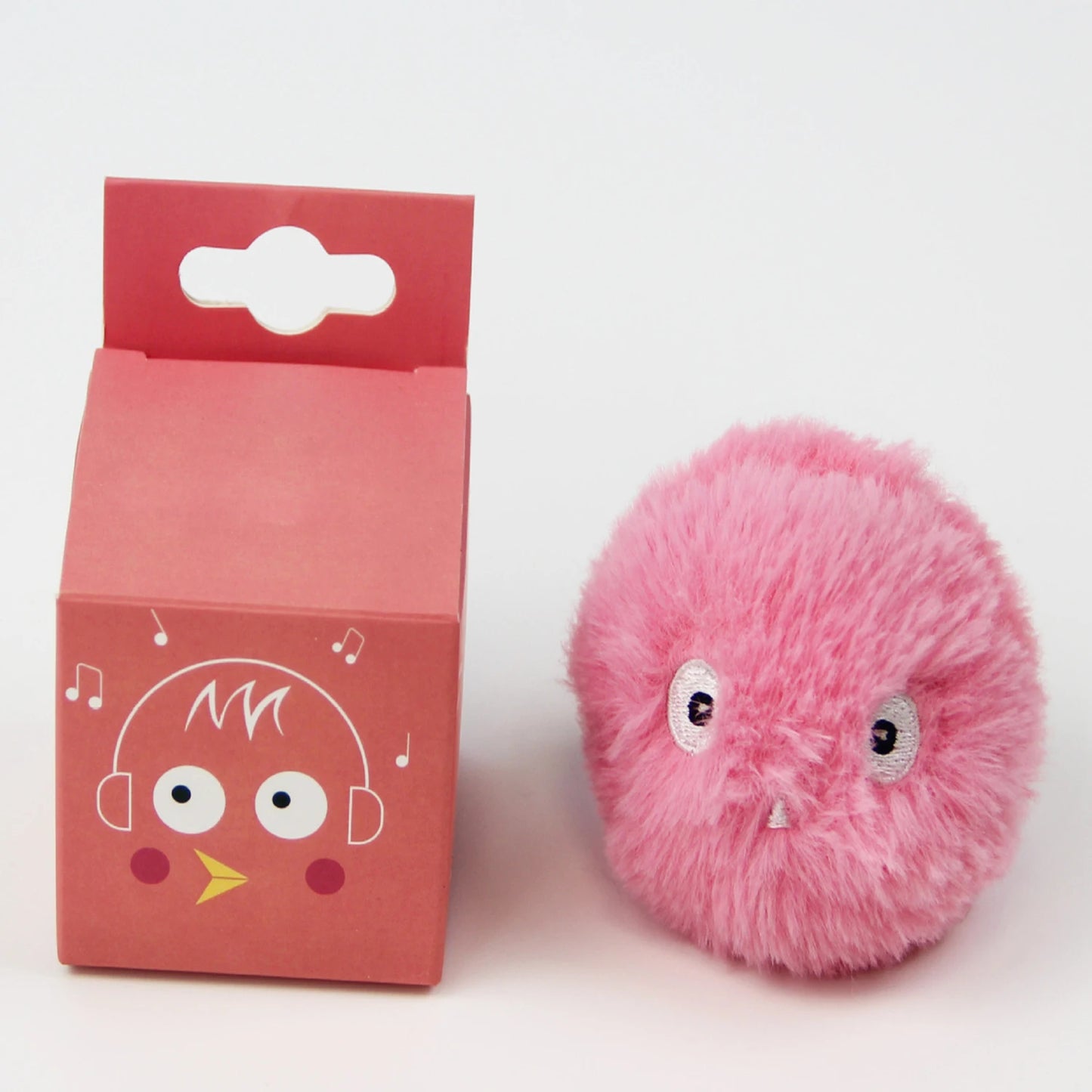 Pink fluffy toy with a matching pink packaging box on a white background