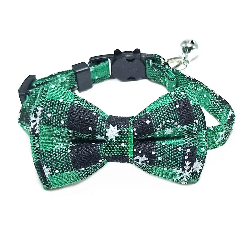 Green and black checkered dog collar with bow tie and bell on a white background