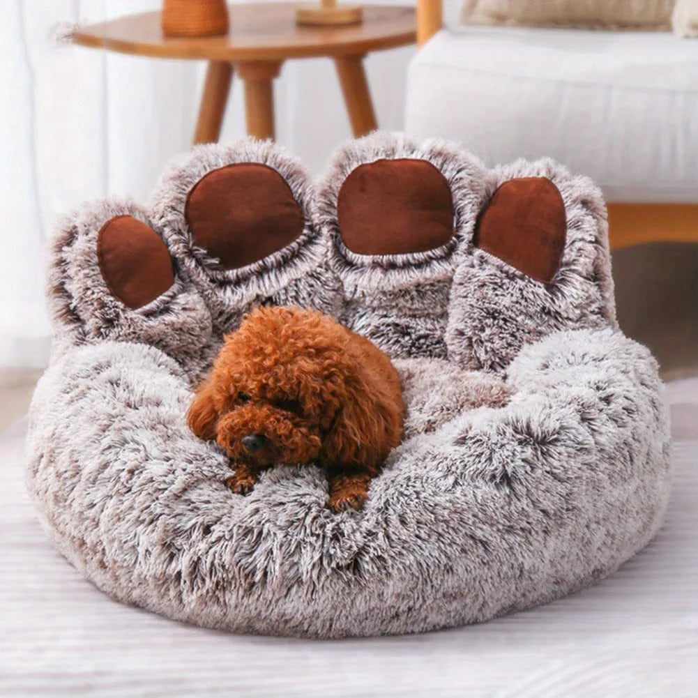 Fluffy pet bed shaped like a bear with a small brown dog inside, in a cozy living room setting.