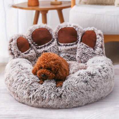 Fluffy pet bed shaped like a bear with a small brown dog inside, in a cozy living room setting.