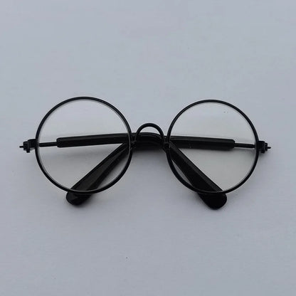 Black round eyeglasses on a light gray background