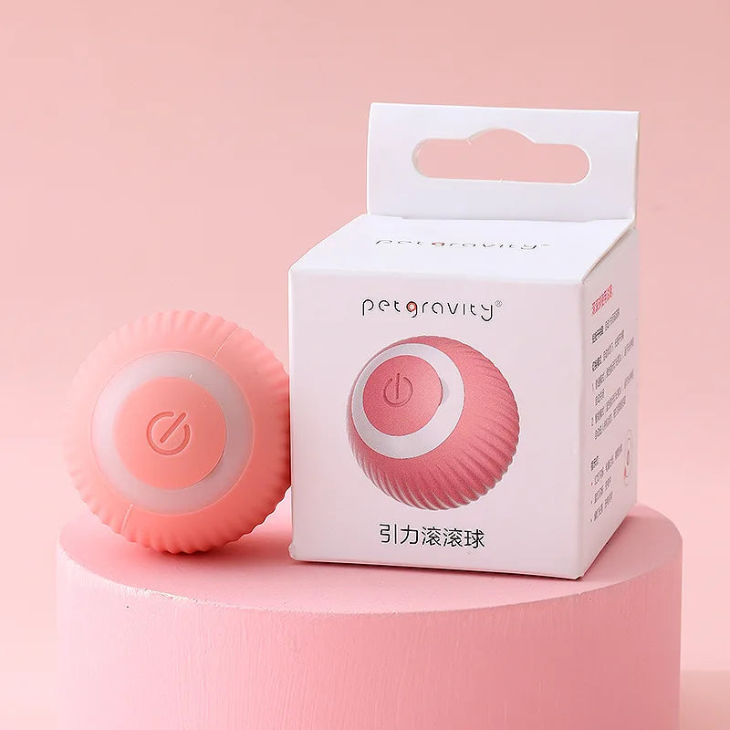 Pink ball with power symbol next to its packaging on a pink background