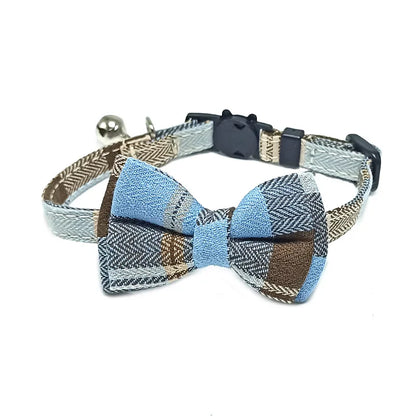 Dog collar with a bow tie featuring blue and brown patterns on a white background
