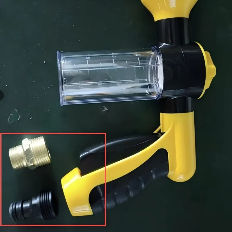 Yellow and black pressure washer gun with clear nozzle on a dark background