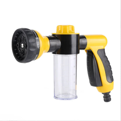 Yellow and black spray gun with various nozzles on a white background