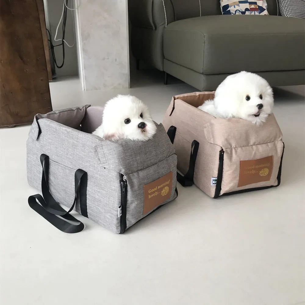 Two small dogs in gray and beige pet carriers on a light-colored floor.