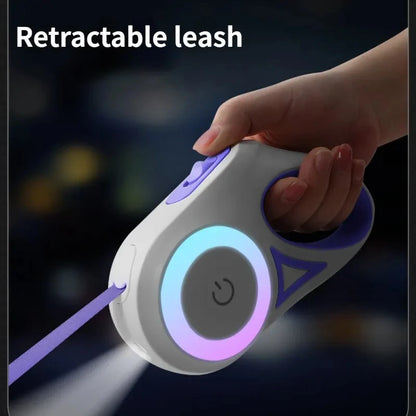 Retractable leash device with hand holding it against a dark background