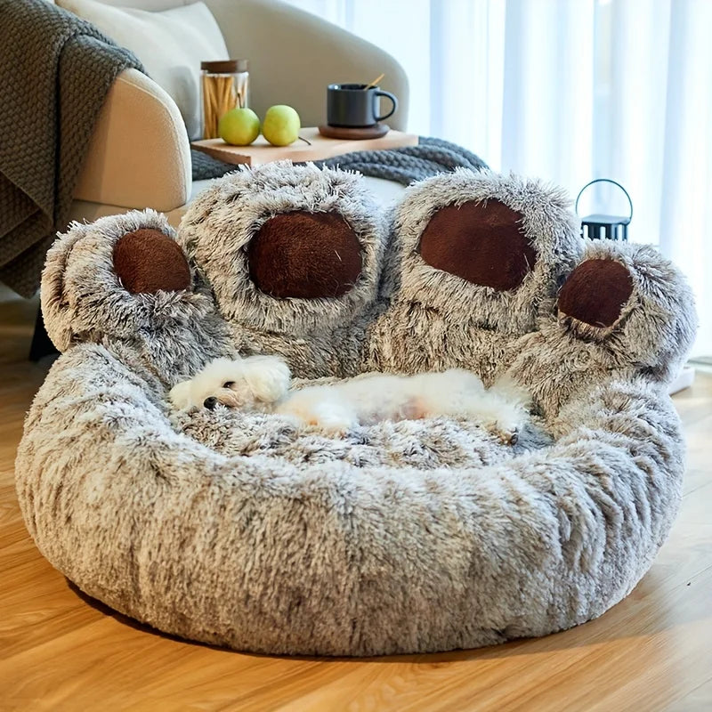 Fluffy pet bed shaped like a bear with a small white dog inside, in a cozy living room.
