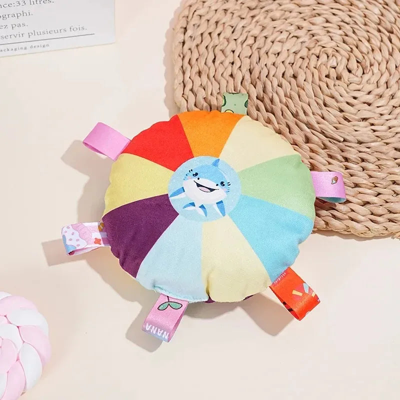 Colorful wheel toy with a cartoon character on a beige surface