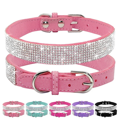 Pink dog collar with rhinestone detailing on a white background