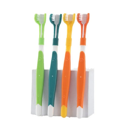 Four colorful toothbrushes with green, blue, yellow, and orange handles on a white background.