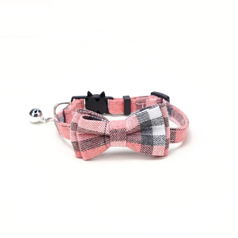 Plaid dog collar with bow tie and bell on a white background