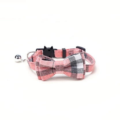 Plaid dog collar with bow tie and bell on a white background