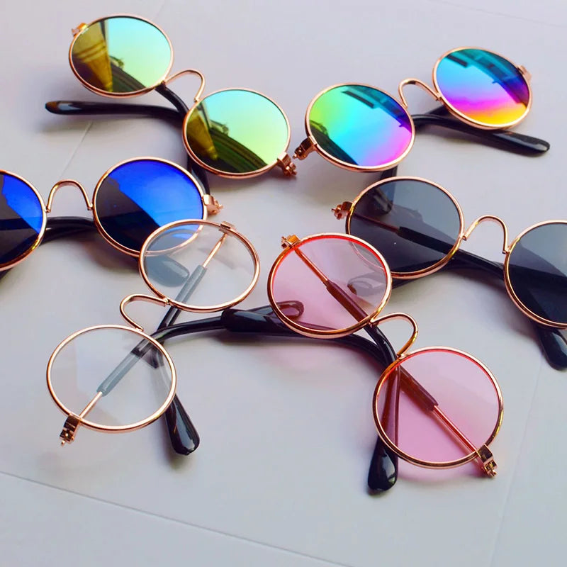 Collection of colorful sunglasses with gold frames on a light background