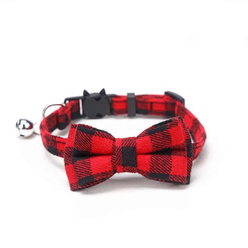 Red and black plaid cat collar with bow tie and bell on a white background