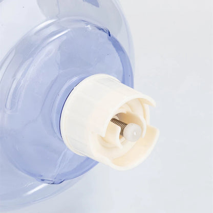 Close-up of a blue water dispenser with a white cap on a light gray background