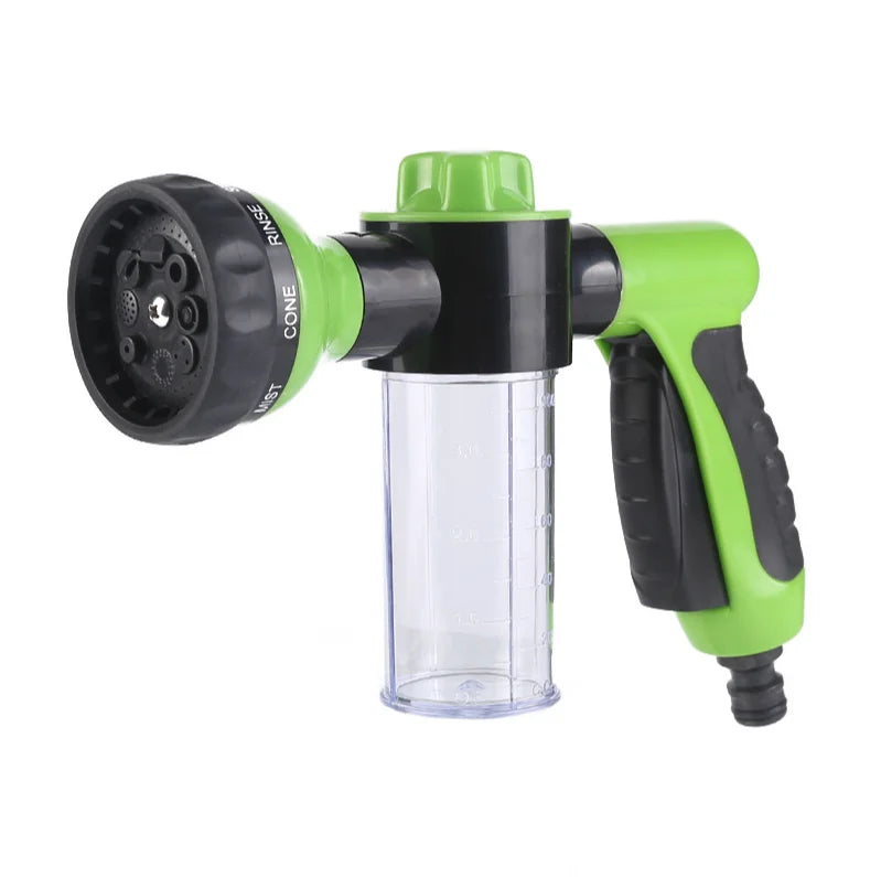 Green and black garden hose nozzle on a white background