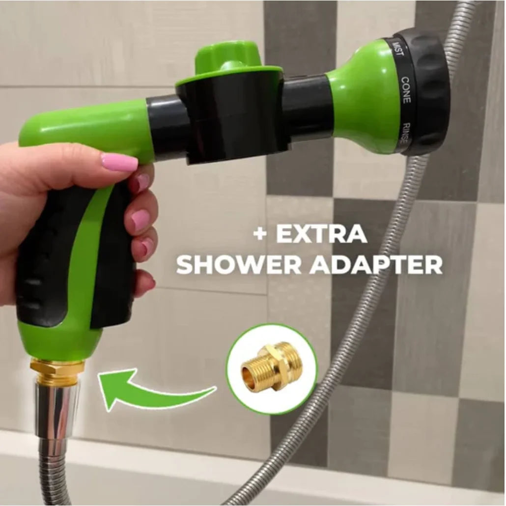 Green and black shower head with an extra shower adapter attached, held by a hand.