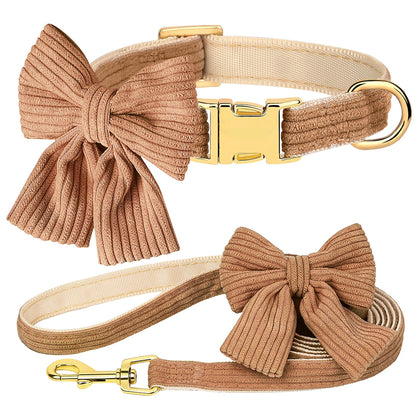 Beige dog collar and leash set with large bows on a white background