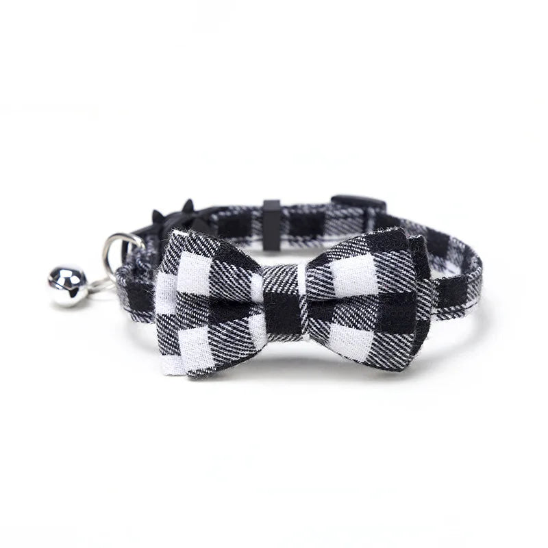 Black and white checkered bow tie collar with bell on a white background