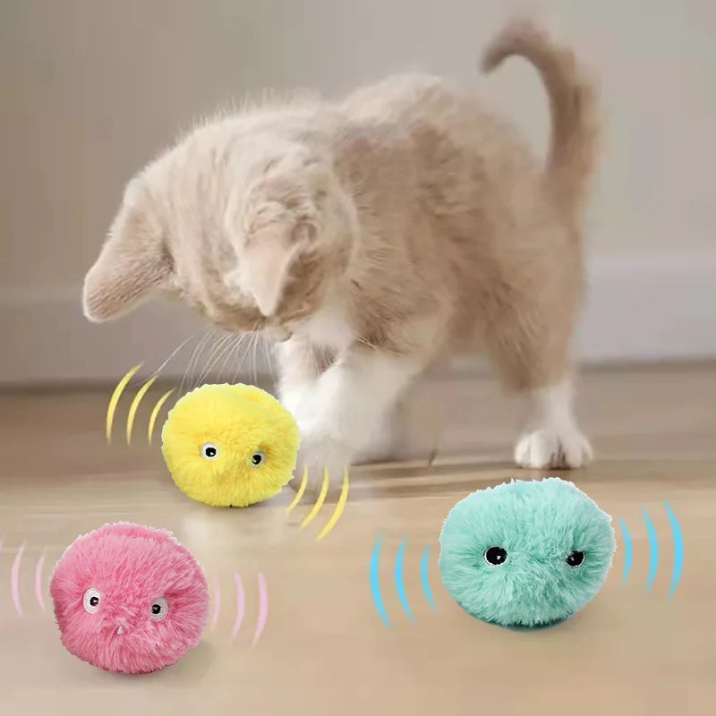 Cat playing with colorful plush toys on a wooden floor.
