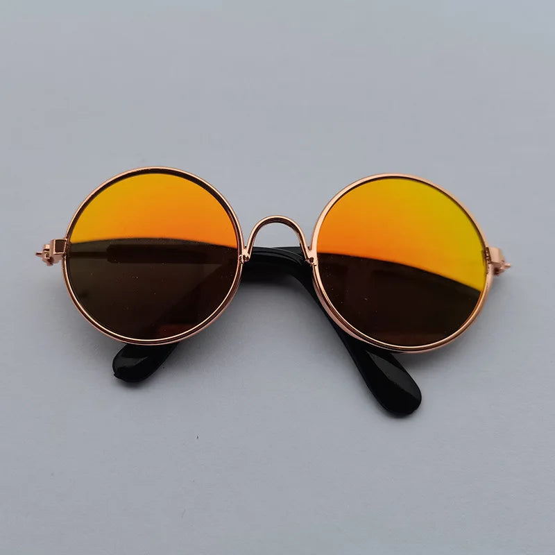 Round sunglasses with rose gold frame and gradient lenses on a gray background