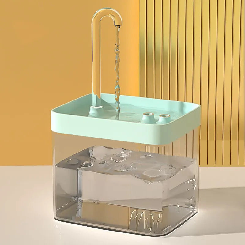 Portable sink with clear base and green top against a yellow wall.