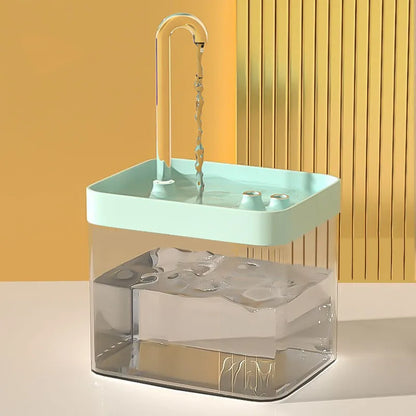 Portable sink with clear base and green top against a yellow wall.