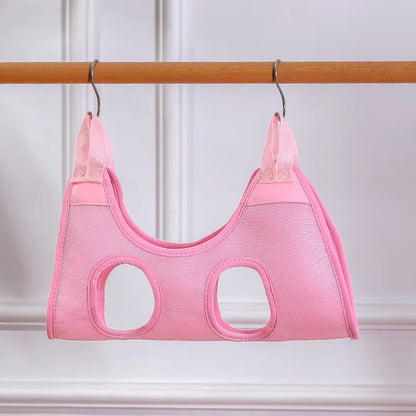 Pink baby carrier on a wooden rod against a white background