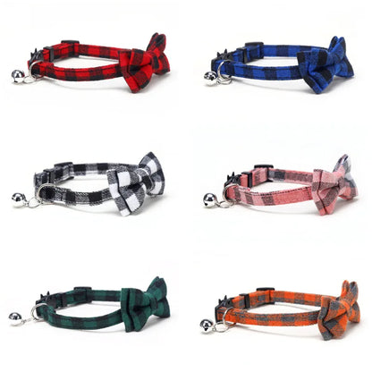 Set of plaid cat collars with bow ties and bells on a white background